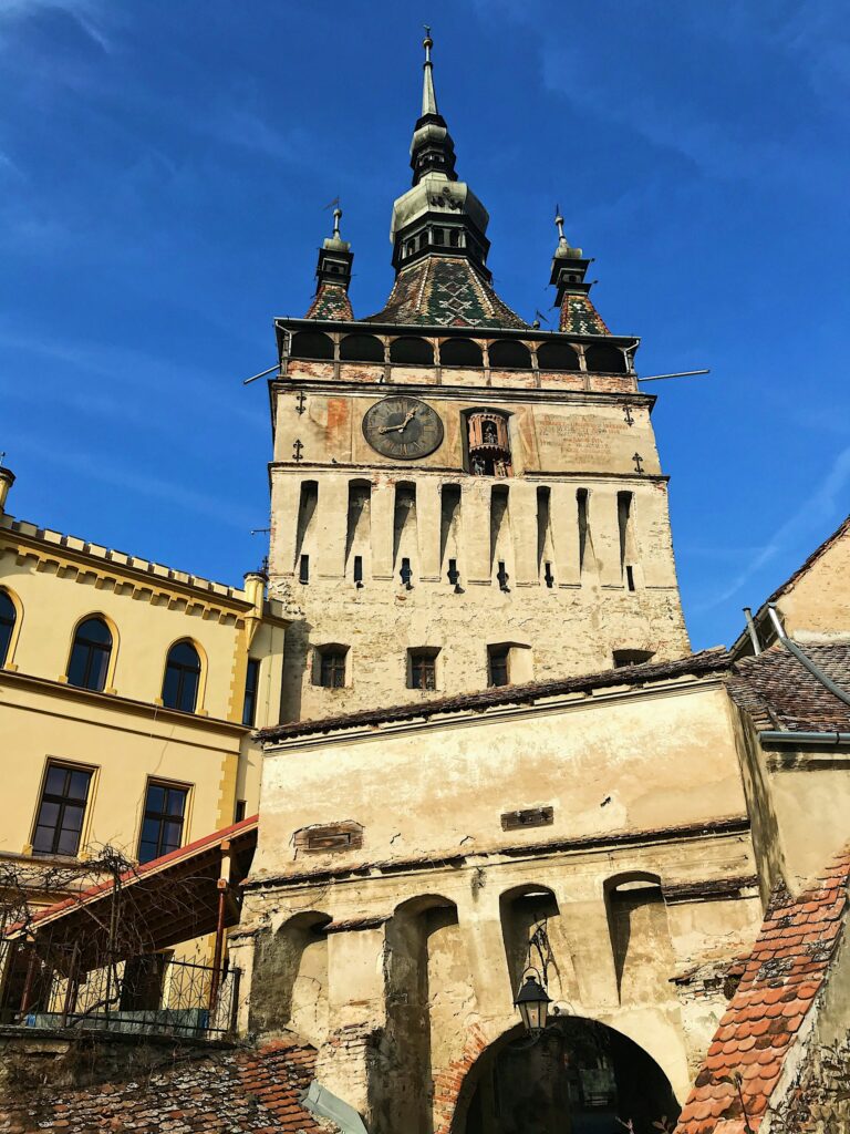 Sighișoara’s Clock Tower and colourful buildings in the medieval citadel, Romania